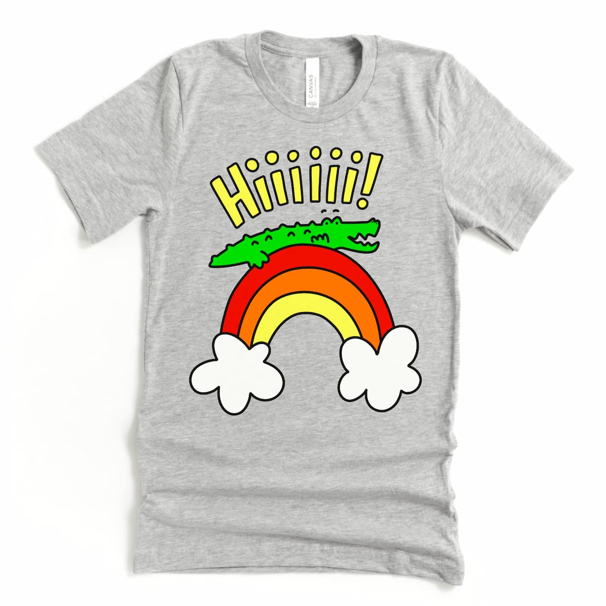 Flat lay of grey alligator shirt showing cheerful cartoon gator on a rainbow saying hi, by Kalirally