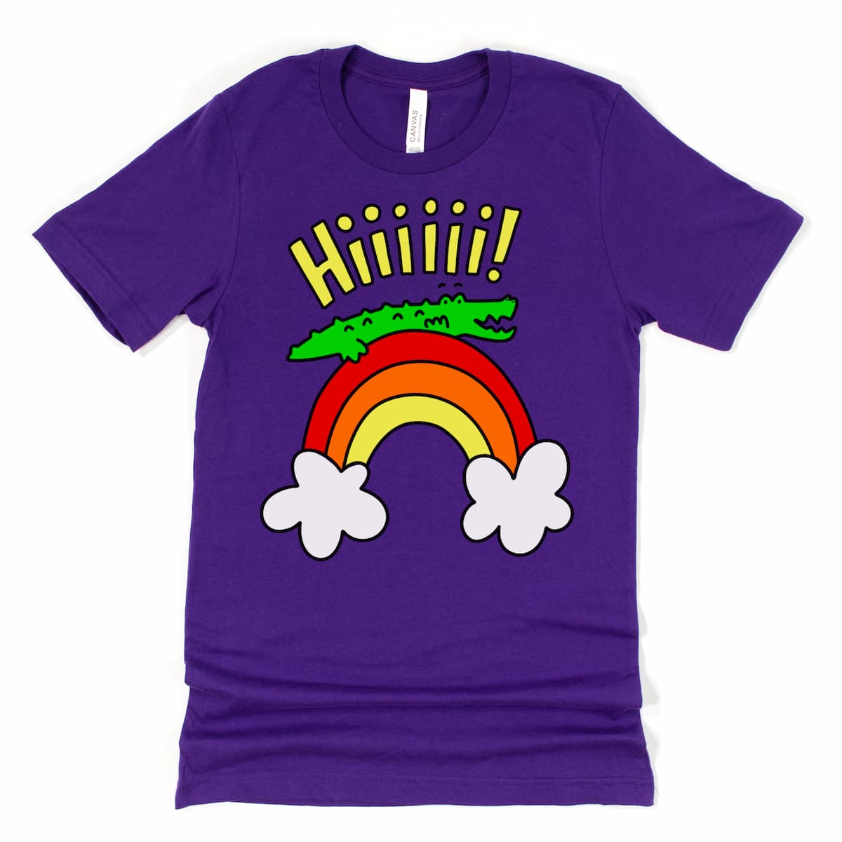Flat lay of a dark purple alligator shirt with smiling cartoon gator on rainbow waving “Hiiii!”