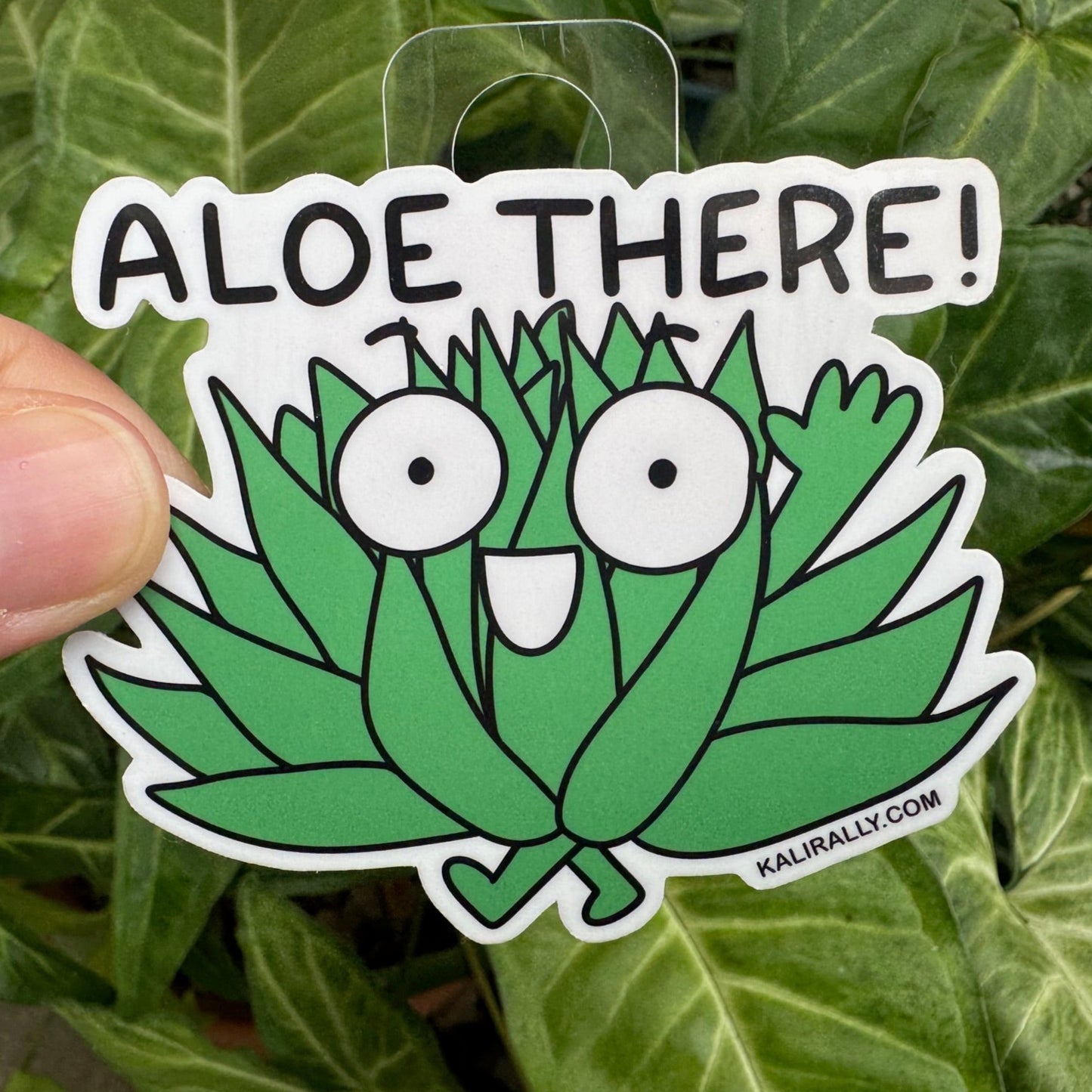 Cute aloe vera sticker with pun “Aloe There!” in a cartoon style by Kalirally