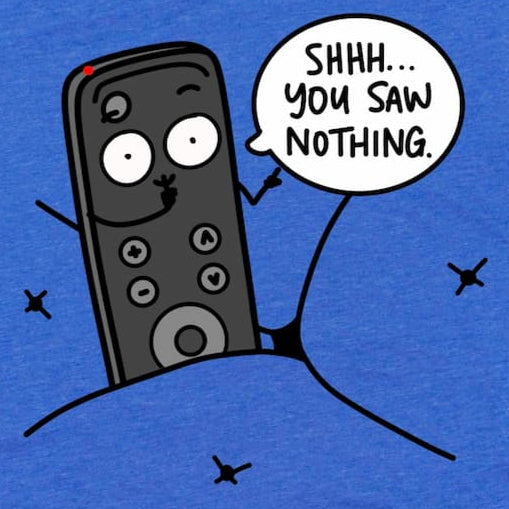 Cropped close-up of cartoon TV remote shirt in Heather True Royal Blue showing a cartoon remote hiding in the couch and saying, “Shhh, You Saw Nothing” phrase, by Kalirally