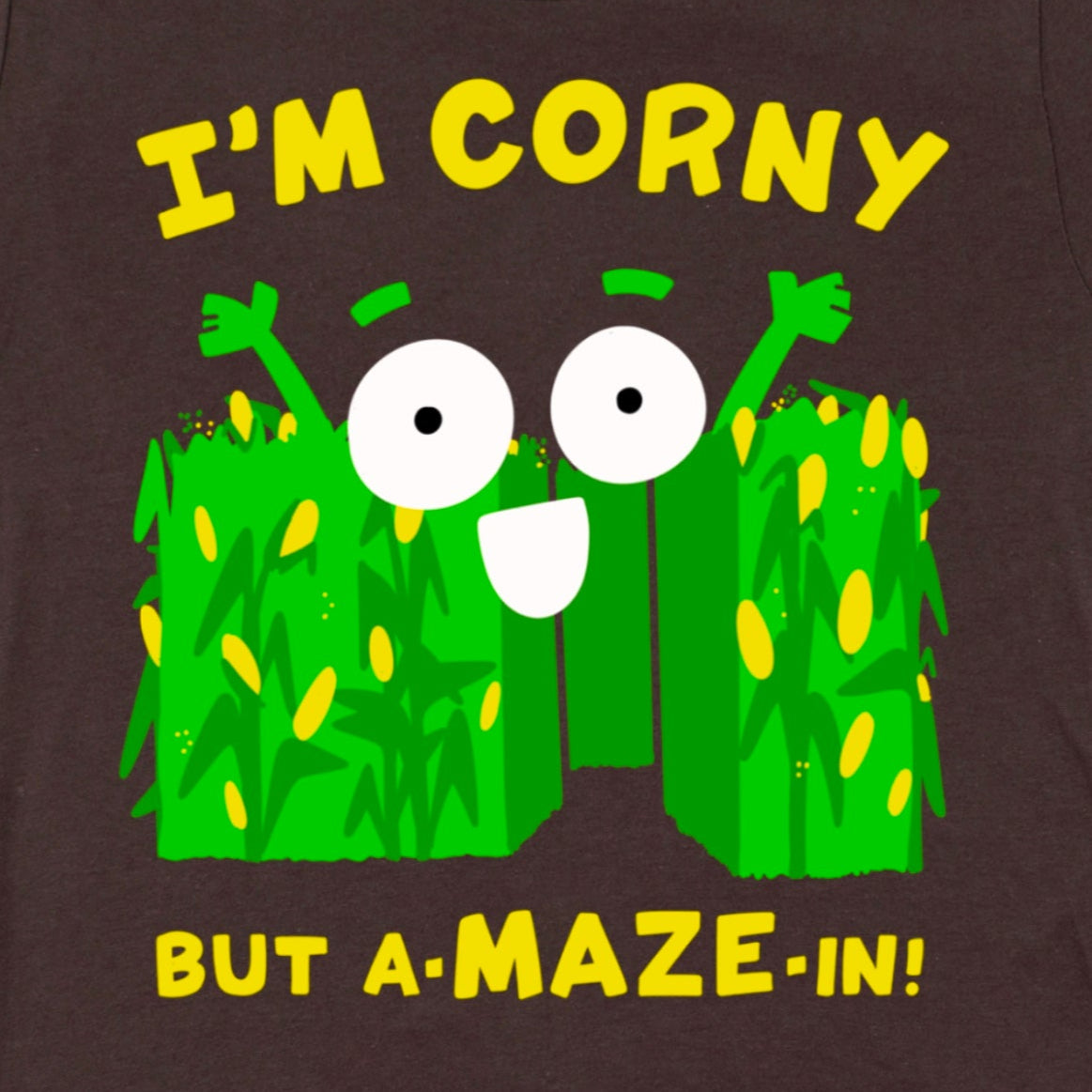 Close-up of Corn Maze Shirt in Brown showing cartoon corn maze with “Corny but A-MAZE-in!” pun, witty autumn dad joke design by Kalirally