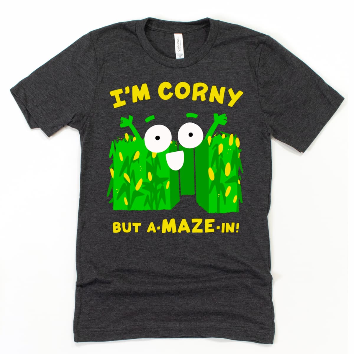 Corn Maze Shirt in Heather Dark Grey showing cartoon corn maze with pun “Corny but A-MAZE-in!” fun autumn harvest graphic shirt by Kalirally