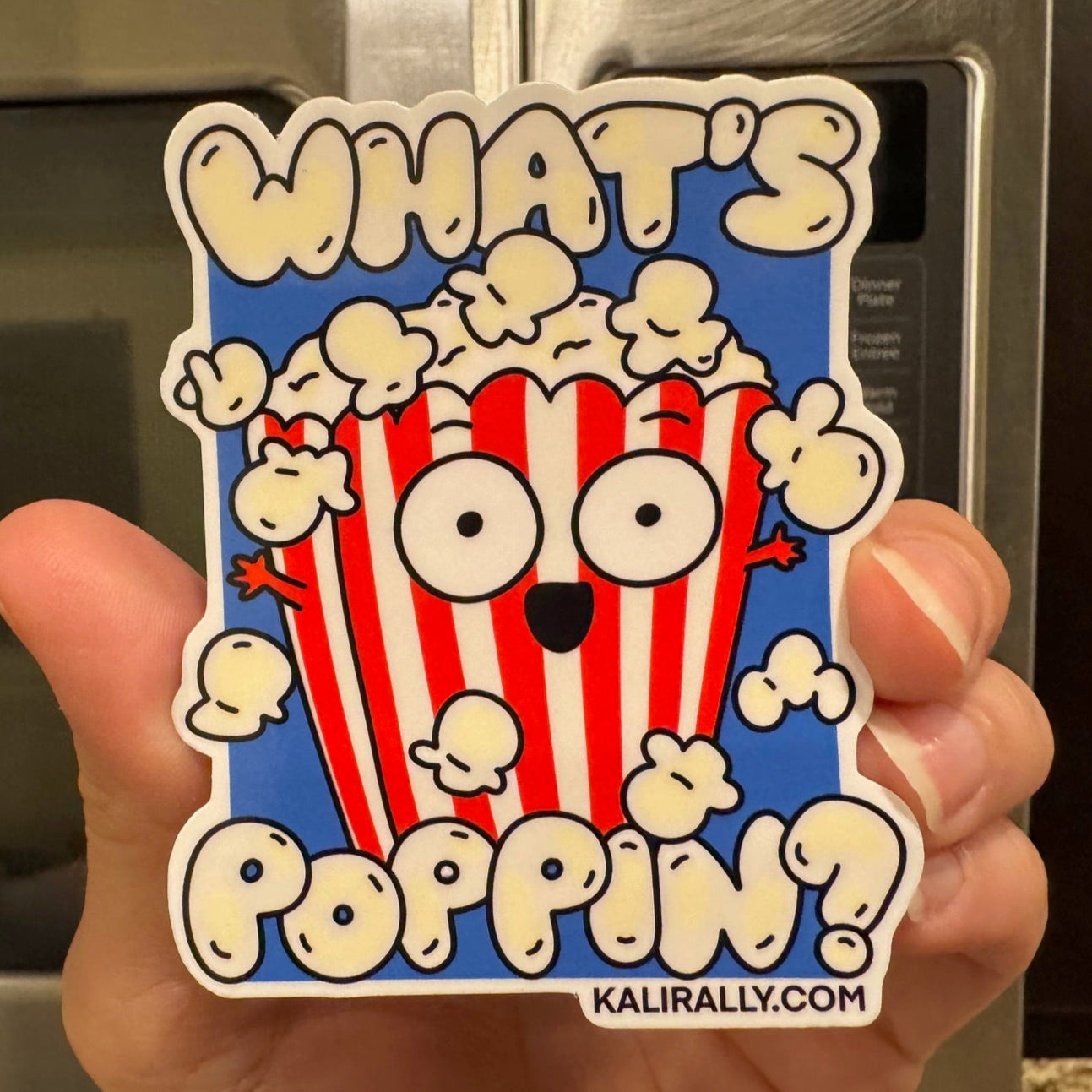 Sticker with a popcorn character and text 'What's Poppin?' held in front of a microwave, by Kalirally