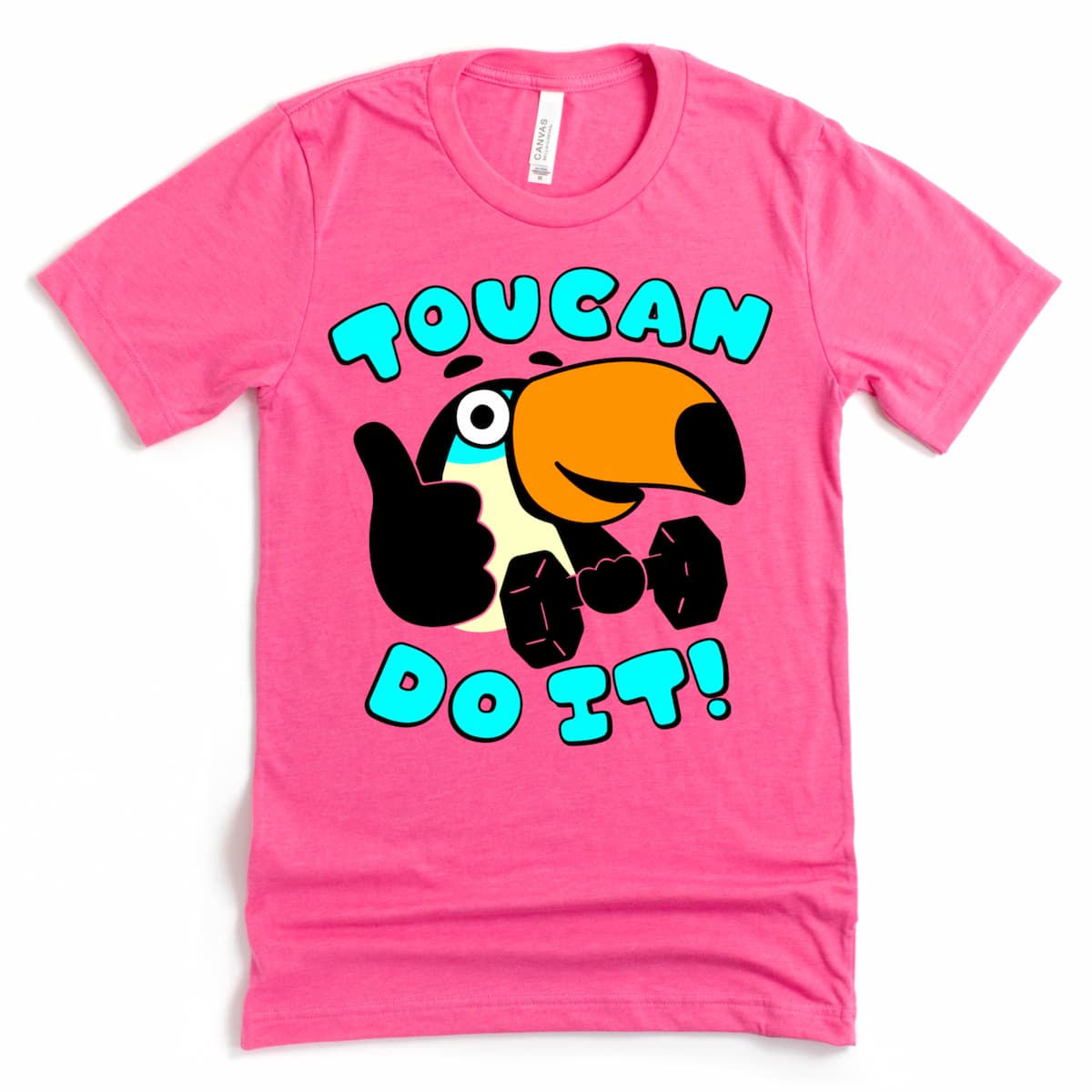 Pink t-shirt flat lay with cheerful toucan holding a dumbbell and flashing a thumbs up.