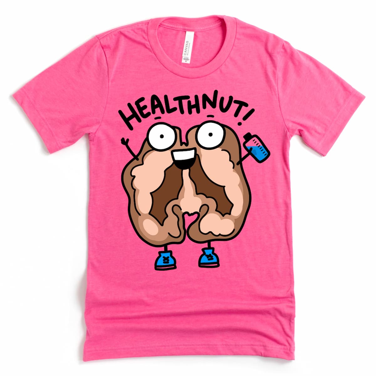 Flat lay of Kalirally healthnut shirt in pink with cute cartoon walnut jogging and saying 'Healthnut!' – wellness and fitness tee