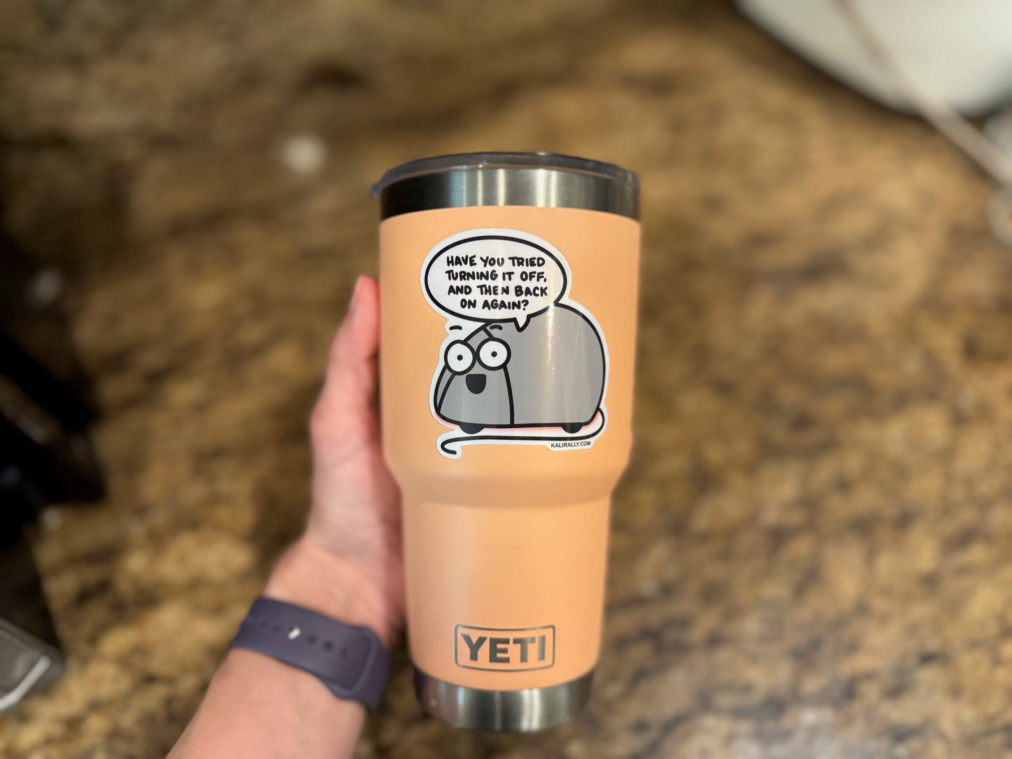 A picture of an approximately 3x3" vinyl sticker of a cartoon computer mouse that is saying, "have you tried turning it off and then back on again? hand drawn by Kalirally