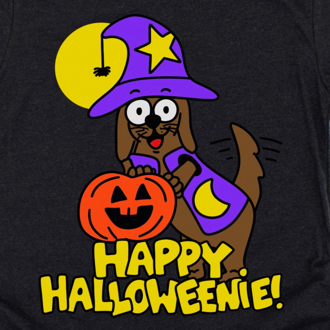 Black T-Shirt featuring cartoon dachshund dressed as a hot dog with the phrase “Happy Halloweenie,” cute and funny Halloween graphic tee by Kalirally