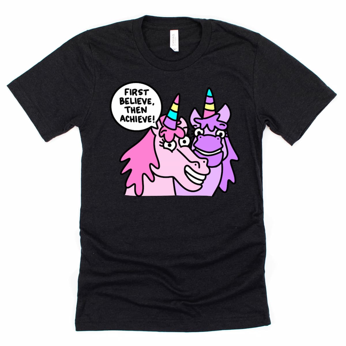 Heather Black unicorn shirt featuring colorful cartoon unicorn and inspiring phrase “First Believe, Then Achieve.”, by Kalirally