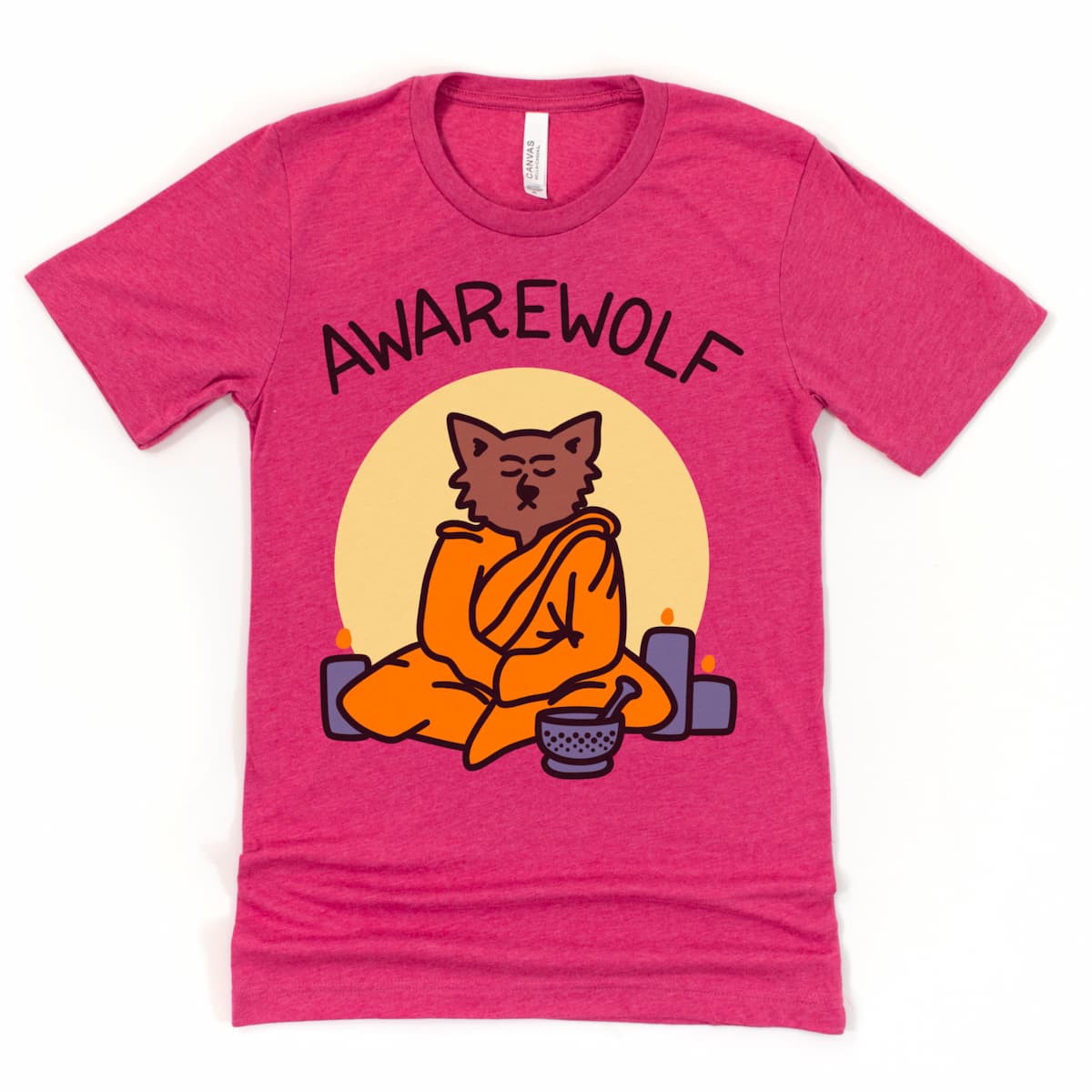 Flat lay of a heather raspberry Werewolf Yoga Halloween shirt with a werewolf meditating in front of a full moon, dressed in robes with candles and a sound bowl.
