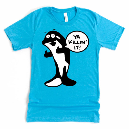 Flat lay of heather aqua orca whale t shirt with smiling killer whale cartoon – by Kalirally