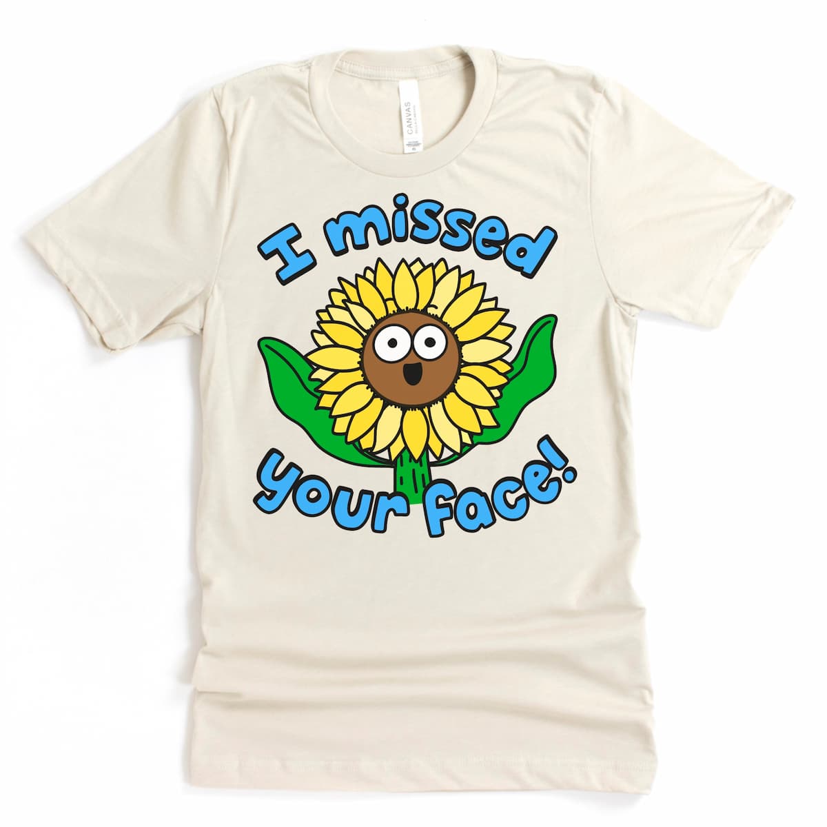 Cute friendship t-shirt in soft heather dust with a Sunflower reaching out its leaves and the phrase “I missed your face!” – Kalirally