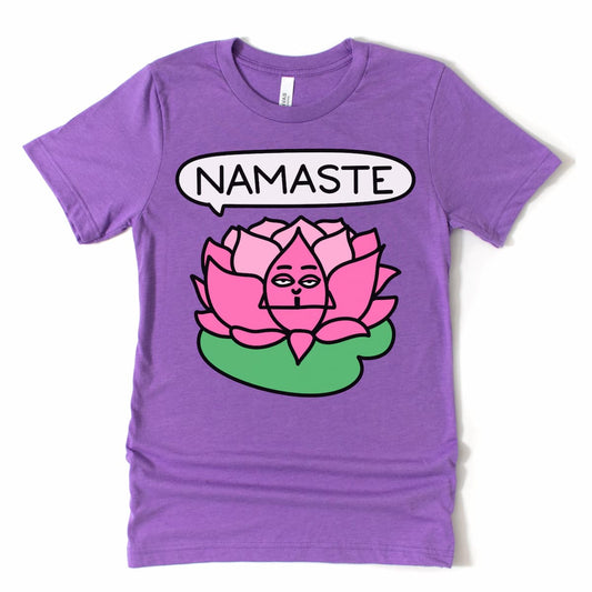 Flat lay of purple yoga t-shirt with seated lotus cartoon and “Namaste” text – calming women's yoga shirt