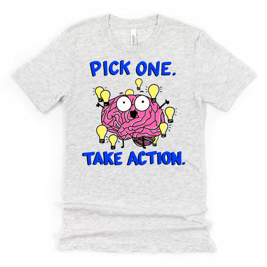 ADHD T Shirt in Heather Ash with cartoon brain staring at glowing lightbulbs and phrase “Pick one, take action,” by Kalirally