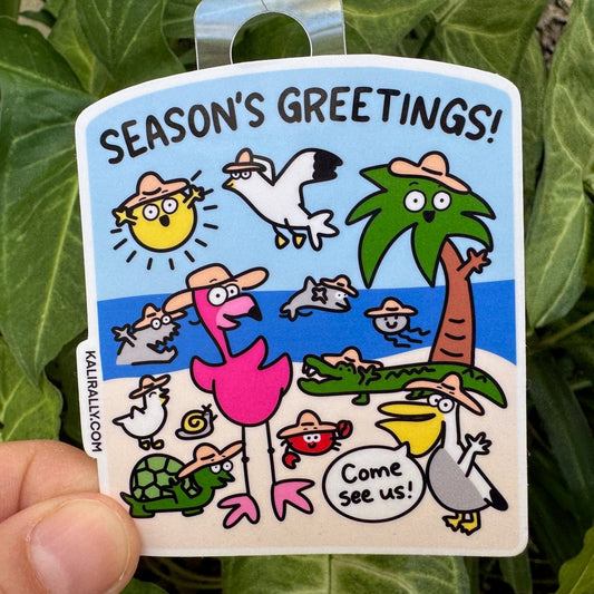 Vinyl beach sticker with the phrase “Seasons Greetings!” and beach-themed graphics — perfect holiday decal, by Kalirally