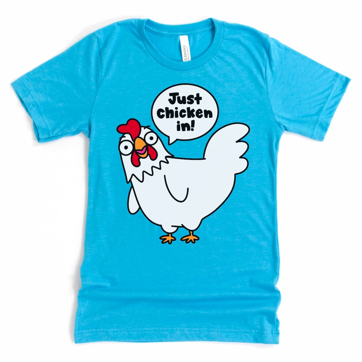 Funny chicken tee in heather aqua with tilted chicken and speech bubble  with saying, "Just chicken in " by Kalirally
