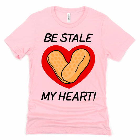 Circus Peanut Shirt in Pink with cartoon stale circus peanut candy and “Be Stale My Heart” phrase, by Kalirally