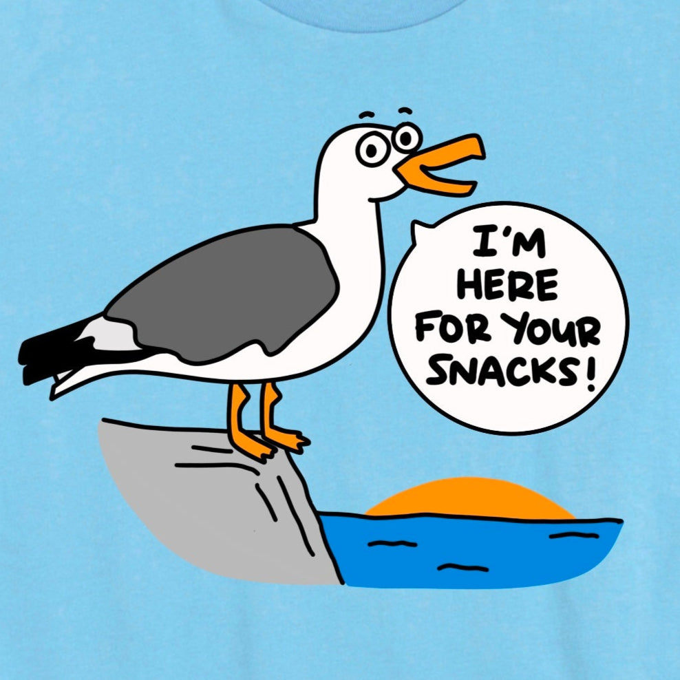 Close-up of Beach Shirt in Ocean Blue showing cartoon seagull with phrase “I’m here for your snacks!” by Kalirally