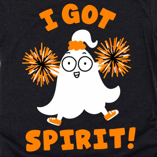 Black Halloween t-shirt design zoomed in, with a ghost cheering with pom-poms and 'I Got Spirit!' text 