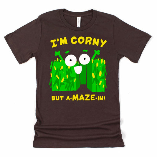Corn Maze Shirt in Brown with cartoon corn maze and pun “Corny but A-MAZE-in!” funny fall graphic tee by Kalirally
