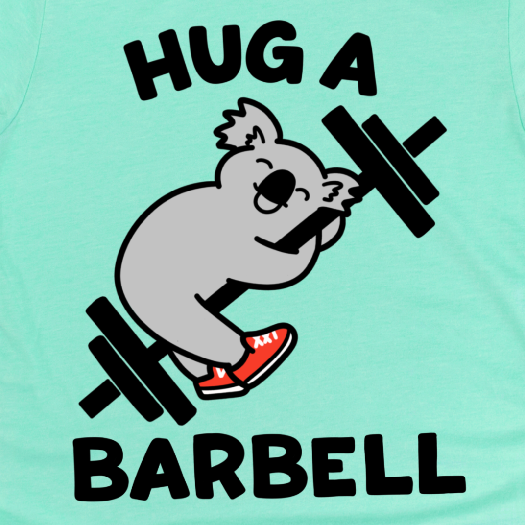 A Close up of a Mint green t-shirt with a graphic of a koala lifting a barbell and text 'HUG A BARBELL' by Kalirally