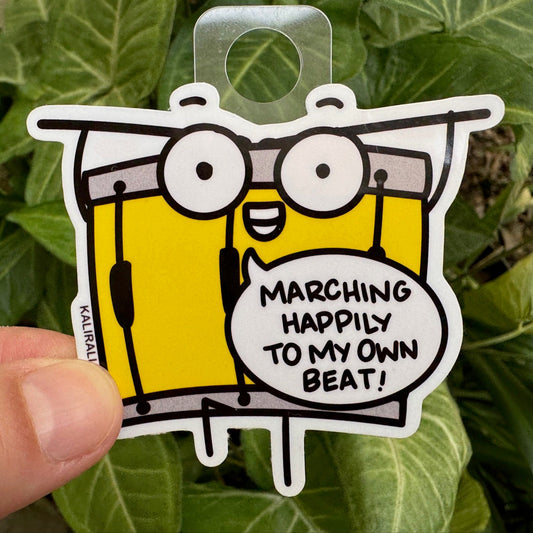 Drum Sticker with cartoon drum and phrase “Marching happily to my own beat,” individuality decal by Kalirally.