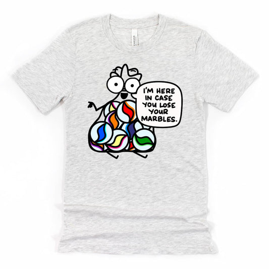 Heather Ash Fun Coworker Shirt with cartoon bag of marbles saying “I’m here in case you lose your marbles,” by Kalirally