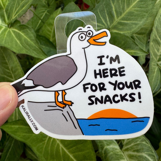 Funny Beach Sticker with cartoon seagull and phrase “I’m here for your snacks!”, playful beach decal by Kalirally
