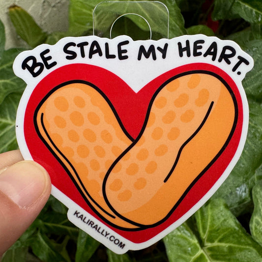 Cartoon circus peanut candy sticker with text “Be stale my heart” — funny retro candy decal for laptops, water bottles, and more by Kalirally