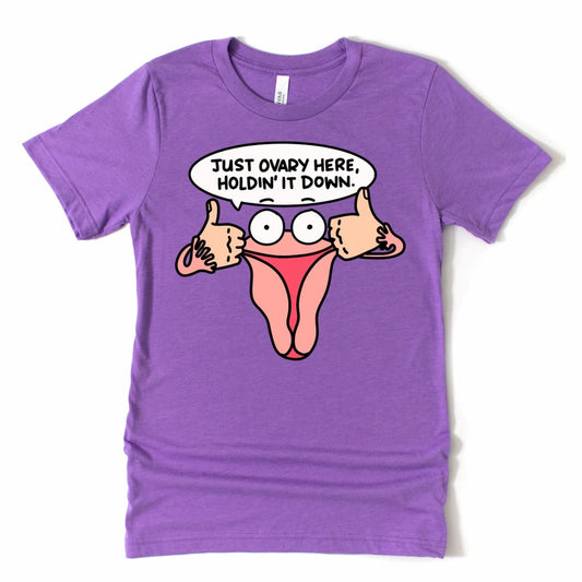 Funny Ovary Shirt in Heather Purple with uterus cartoon saying “Just Ovary Here, Holdin’ It Down,” women’s empowerment tee by Kalirally