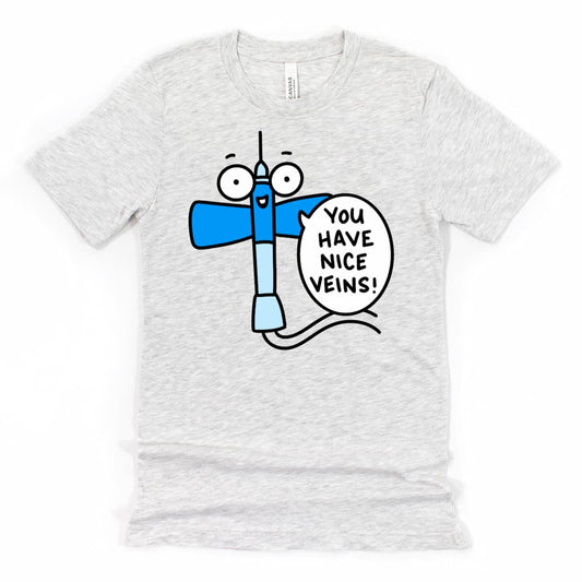 Funny Phlebotomist Shirt in Athletic Grey featuring cartoon butterfly needle saying “You have nice veins!” — perfect gift for medical workers and nurses, by Kalirally