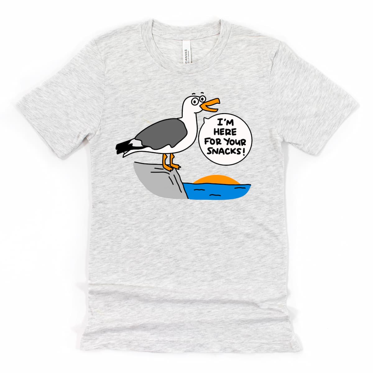 Funny Seagull Beach Shirt in Heather Ash with cartoon seagull saying “I’m here for your snacks!” by Kalirally