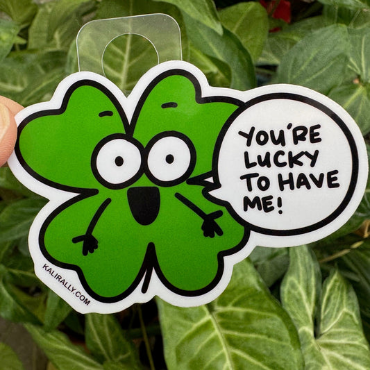 Cartoon four-leaf clover sticker with the phrase "You're Lucky to Have Me!" Fun vinyl decal for water bottles, laptops, notebooks, and lucky charm lovers, by Kalirally.