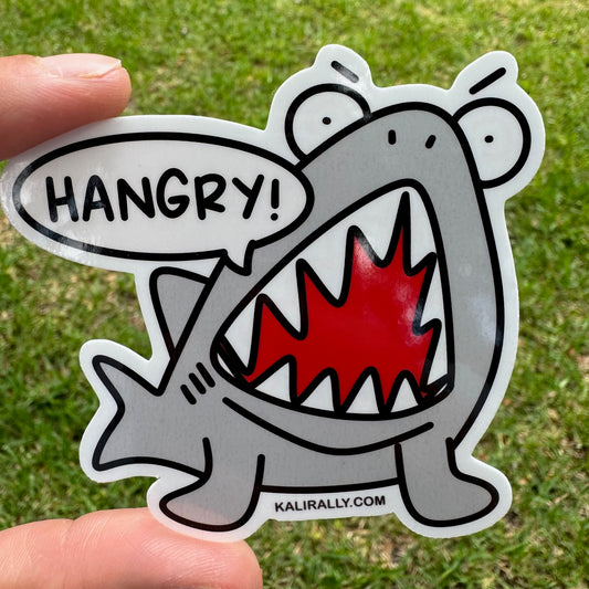 Hangry Sticker by Kalirally featuring a cartoon shark with an annoyed expression. Waterproof vinyl animal sticker for laptops, water bottles, and lunch boxes.
