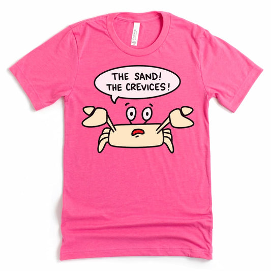 A fun and quirky crab shirt by Kalirally in heather charity pink, shown flat with the dramatic phrase “The Sand! The Crevices!”