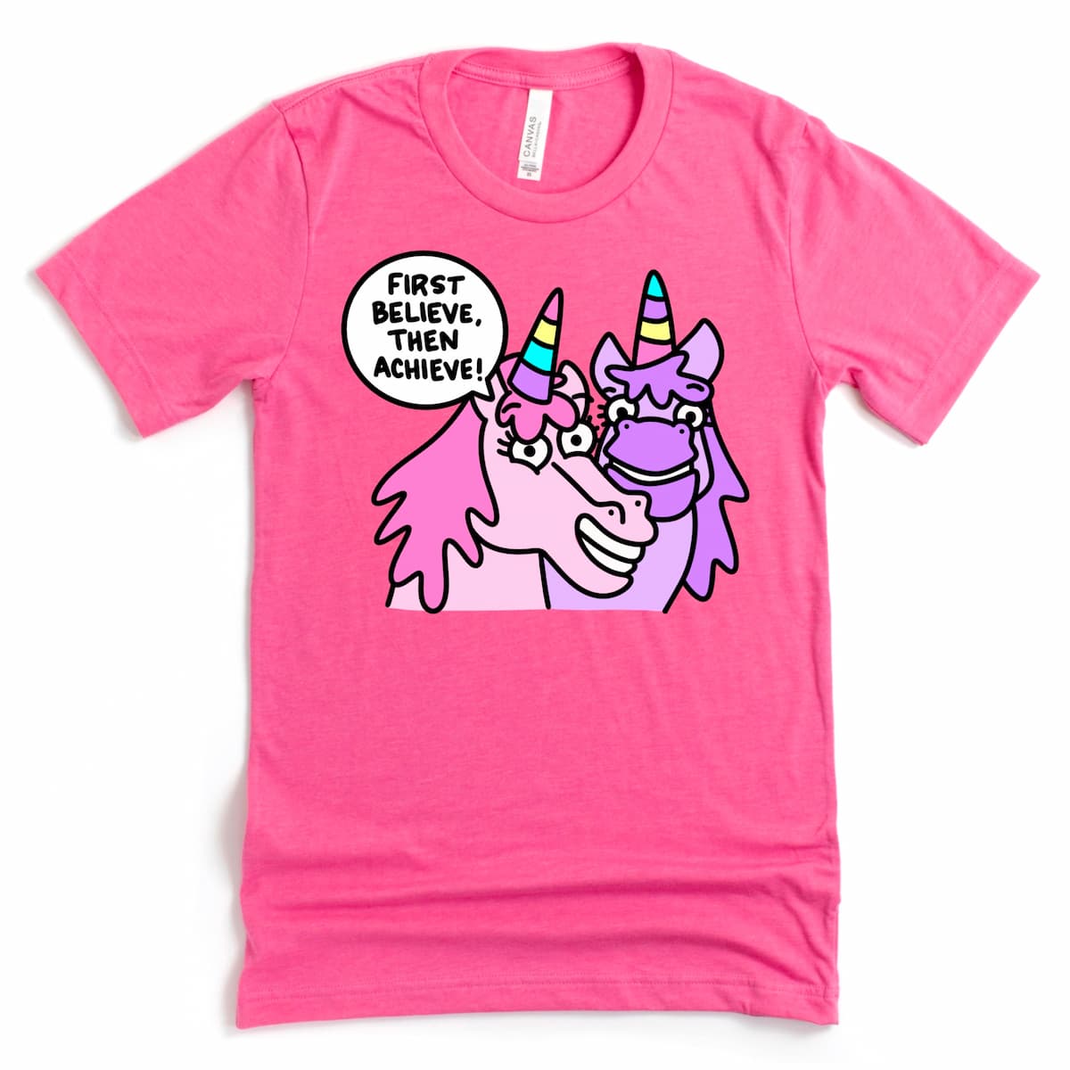 Heather Charity Pink unicorn shirt with fun “First Believe, Then Achieve.” cartoon unicorn design, by Kalirally