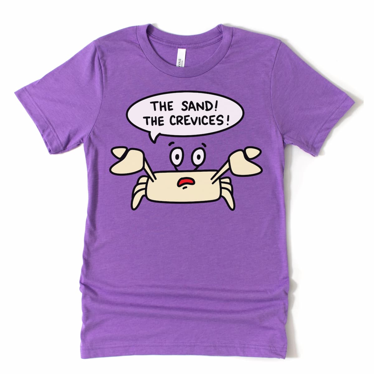 Flat lay of a crab shirt in heather team purple by Kalirally, featuring a panicked crustacean shouting “The Sand! The Crevices!”
