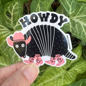 Cartoon armadillo sticker saying “Howdy” wearing a cowboy hat and boots, water resistant Texas decal Kalirally