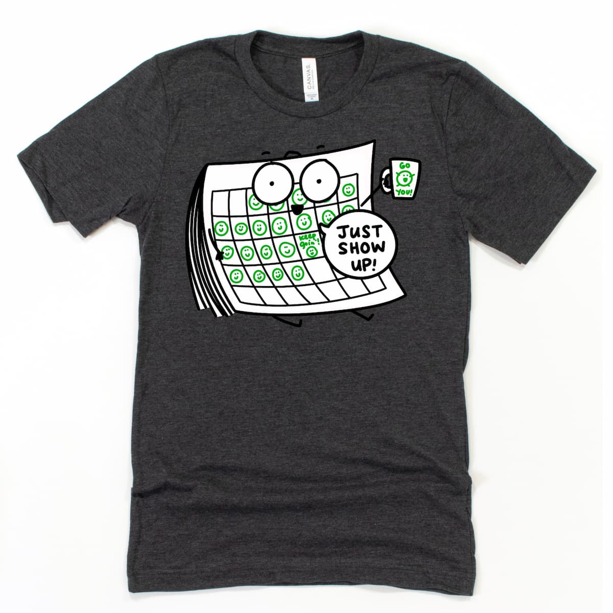 Just Show Up Encouragement Shirt in Heather Dark Grey with cartoon calendar marking progress and happy mug cheering “Go you!”, by Kalirally