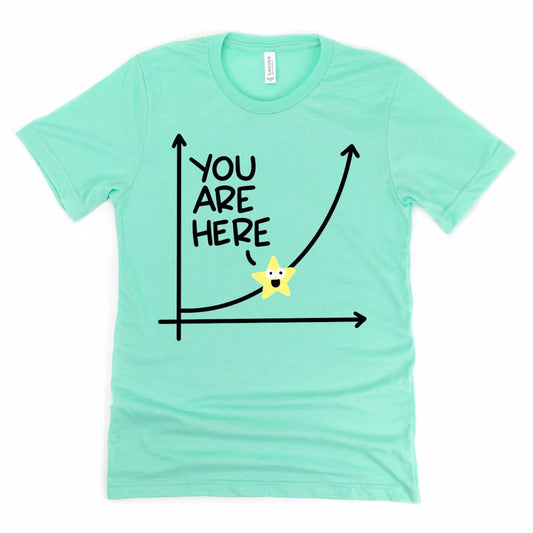 Heather mint green t-shirt with exponential growth graph and “You Are Here” star design, inspirational personal growth shirt by Kalirally