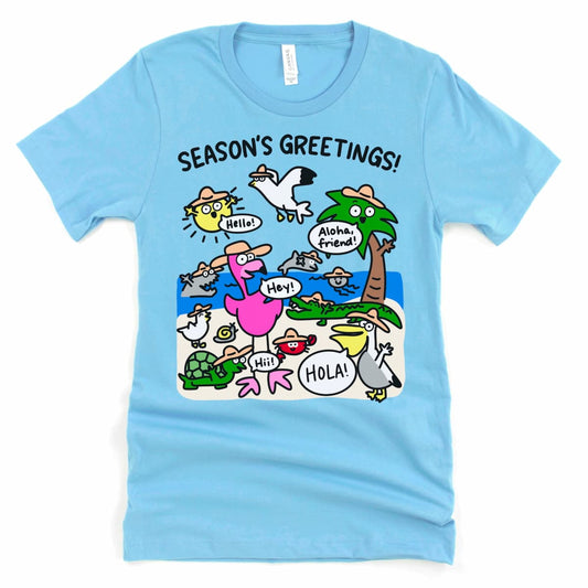 Flat lay of an ocean blue Florida beach shirt from Kalirally featuring a playful “Season’s Greetings”(Beach season) design with beach animals saying hello.