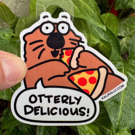 Vinyl Otter Sticker – cartoon otter eating pizza “Otterly Delicious” decal by Kalirally.