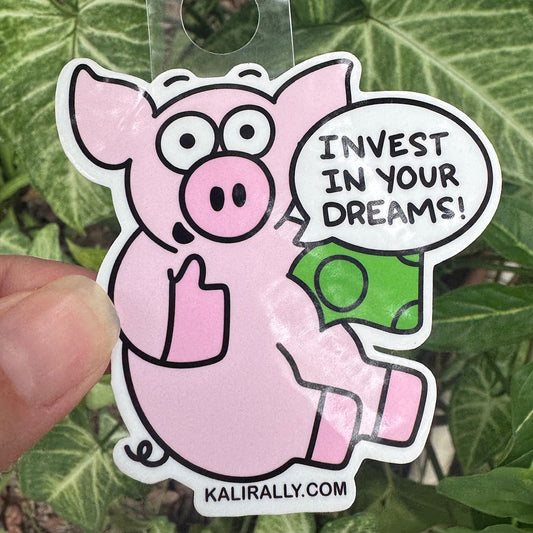 Piggy Bank Sticker featuring a cute cartoon pig with the phrase “Invest in your dreams!” motivational decal by Kalirally