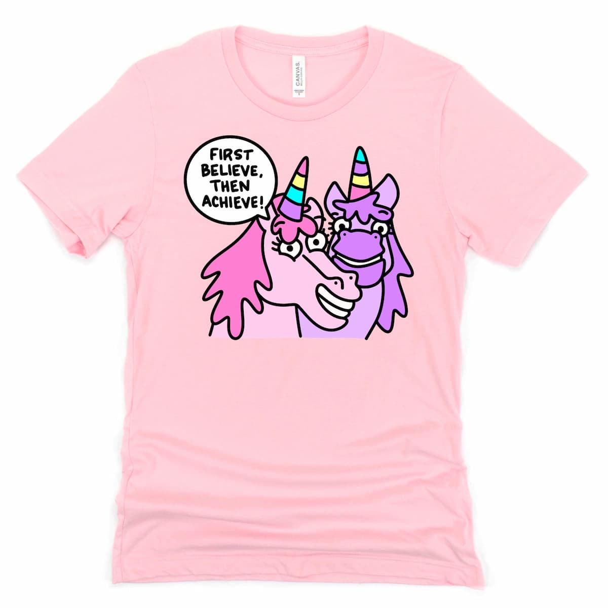 Pink unicorn shirt with playful “First Believe, Then Achieve.” cartoon unicorn design, by Kalirally