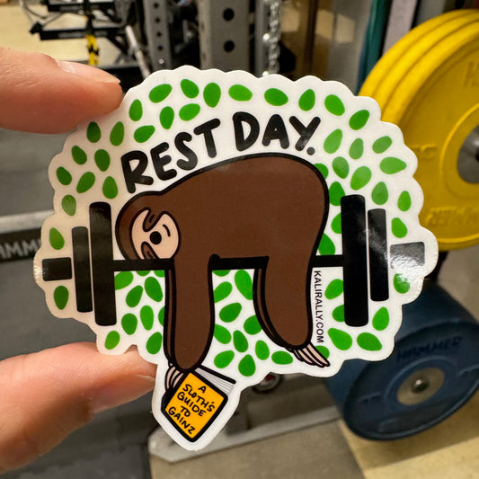 Vinyl Rest Day Gym Sticker featuring a Sloth lying across a barbell with a book titles, "A sloth's guide to gainz" - by Kalirally