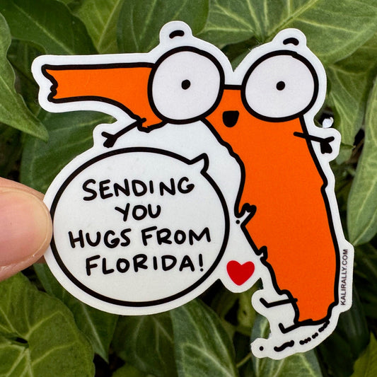 artoon Florida shape with outstretched arms and a heart, with the words “Sending You Hugs from Florida” – cute Florida vinyl sticker, by Kalirally