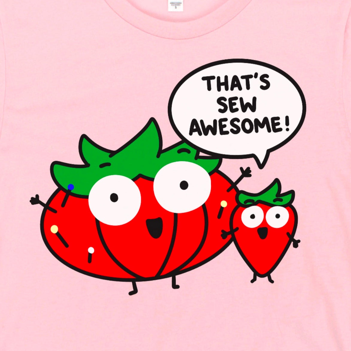Close-up view of “That’s Sew Awesome” design on light pink sewing shirt with pin cushion – Kalirally