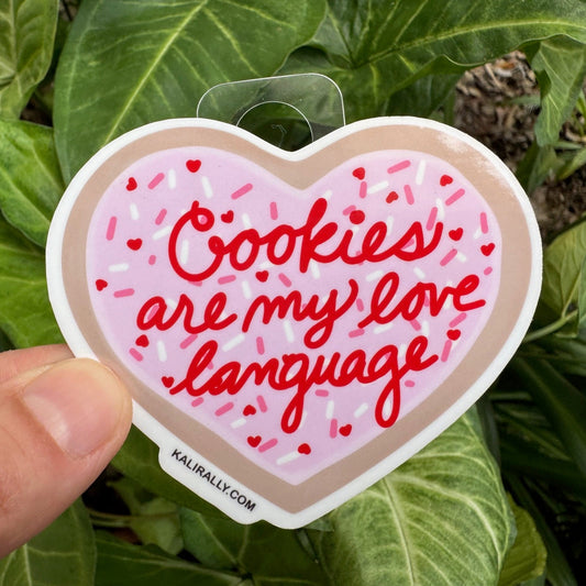 Sugar Cookie Sticker with pink frosted cookie and phrase “Cookies are my love language,” fun baking decal by Kalirally