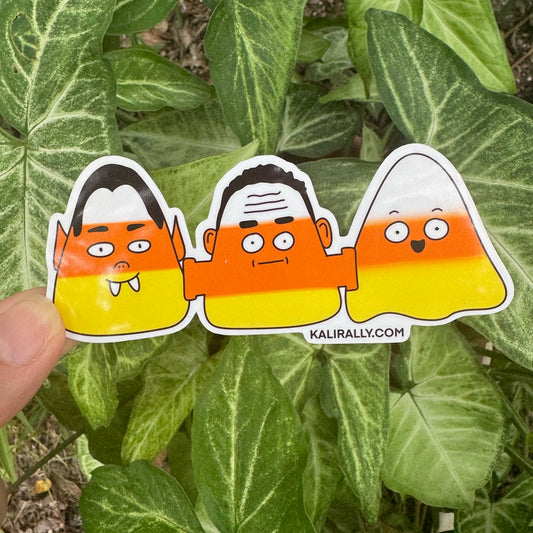 Cute Triple Candy Corn Sticker with vampire, Frankenstein, and ghost characters in candy corn design, waterproof vinyl decal for Halloween by Kalirally.