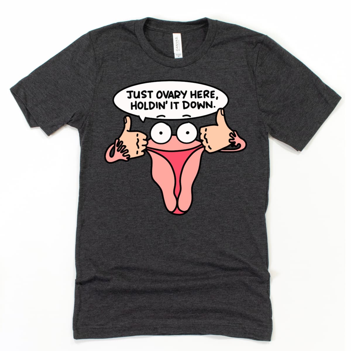 Heather Dark Grey Funny Ovary Shirt with uterus cartoon graphic and humorous feminist message “Just Ovary Here, Holdin’ It Down” by Kalirally