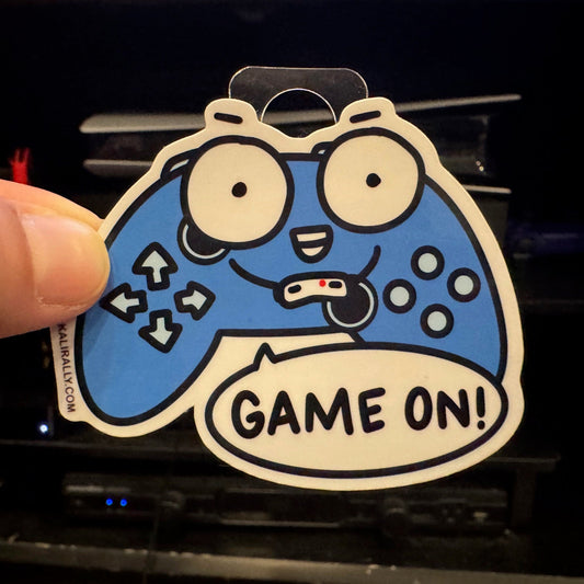 Video game sticker featuring a colorful cartoon controller with the words "Game On!" Waterproof vinyl gamer decal for laptops, water bottles, and consoles.